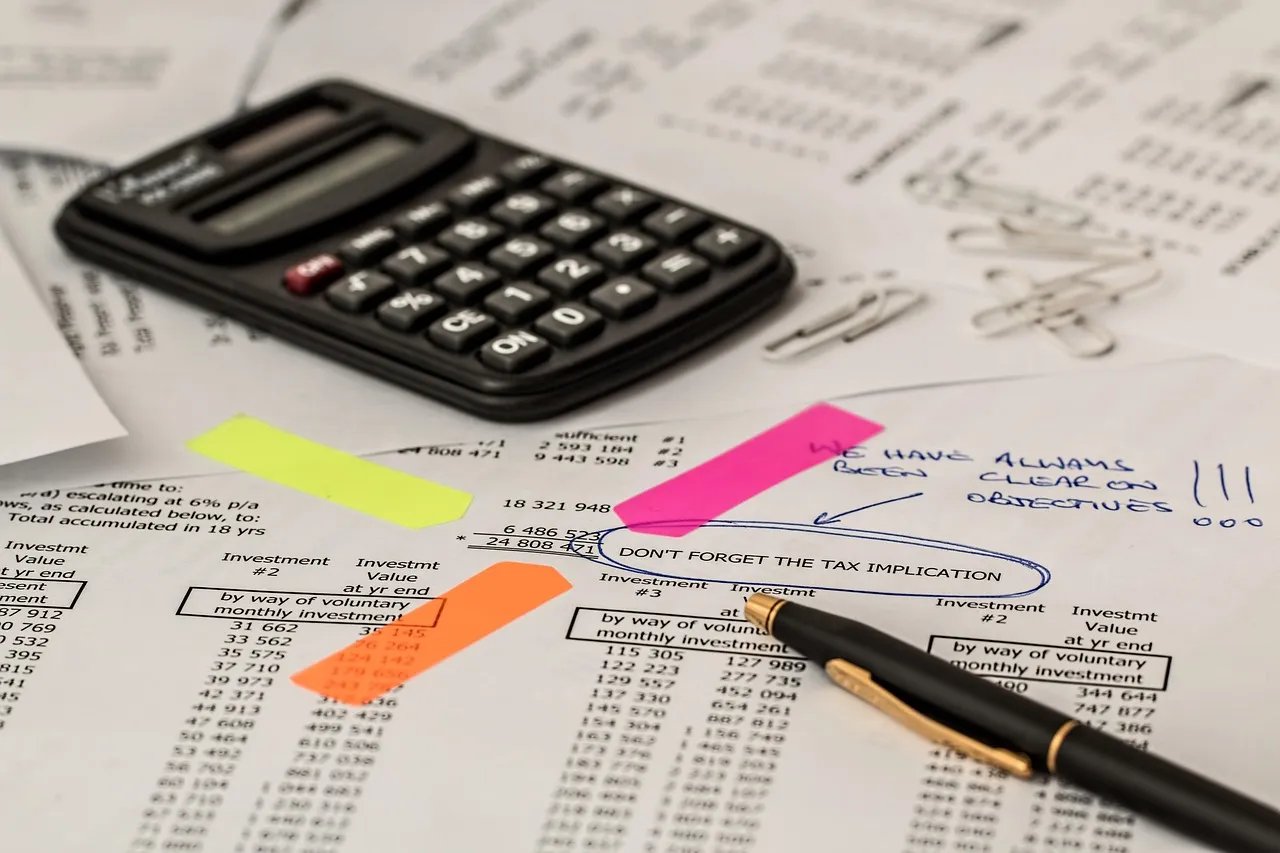 A calculator resting on papers during a cost calculation.