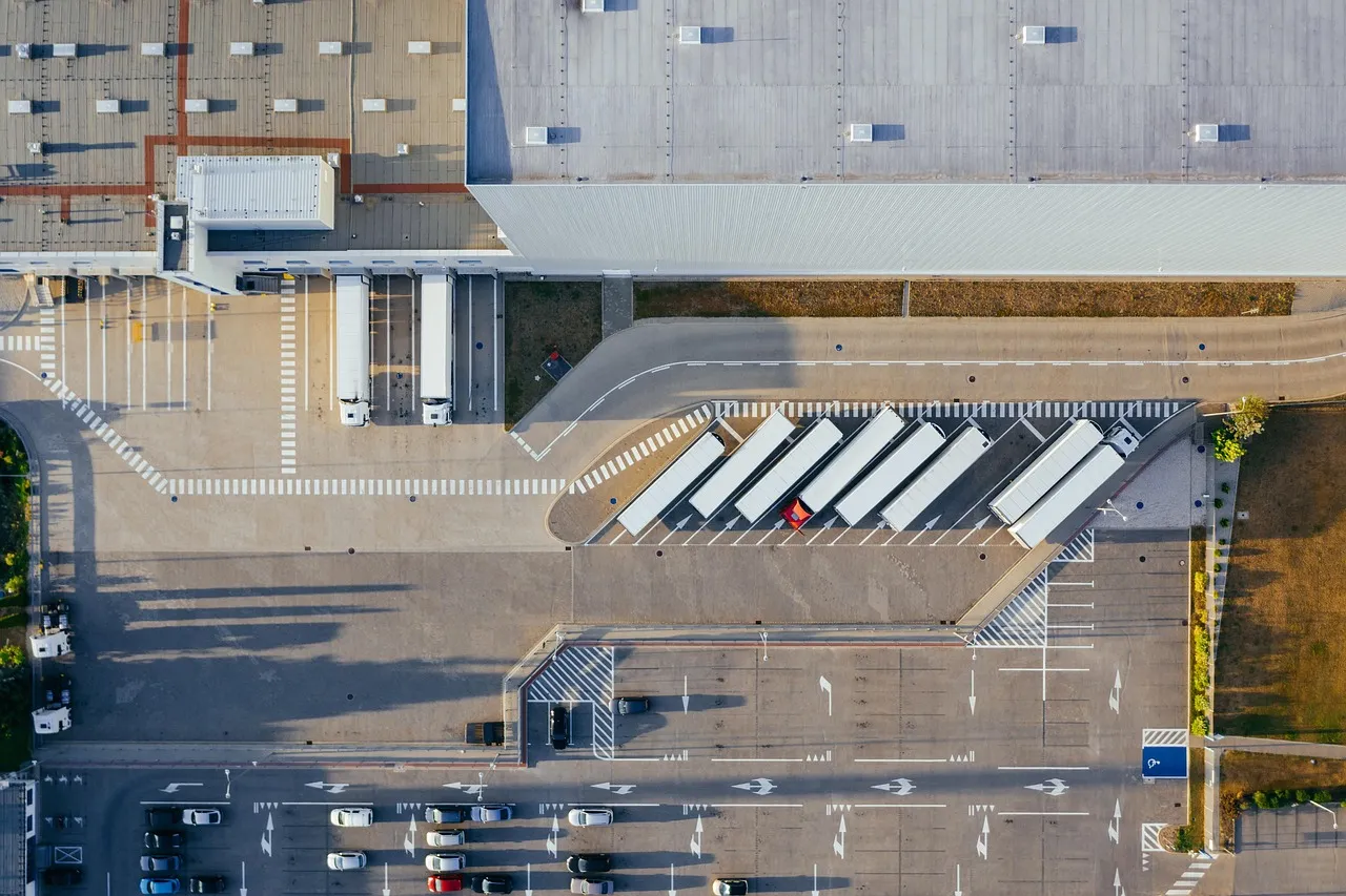 A busy distribution center with loading bays and trucks.