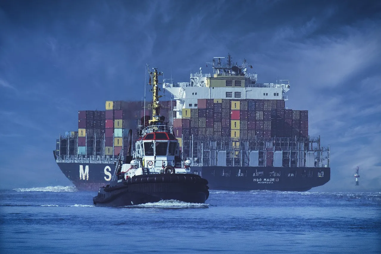 A container ship loaded with cargo containers at sea.